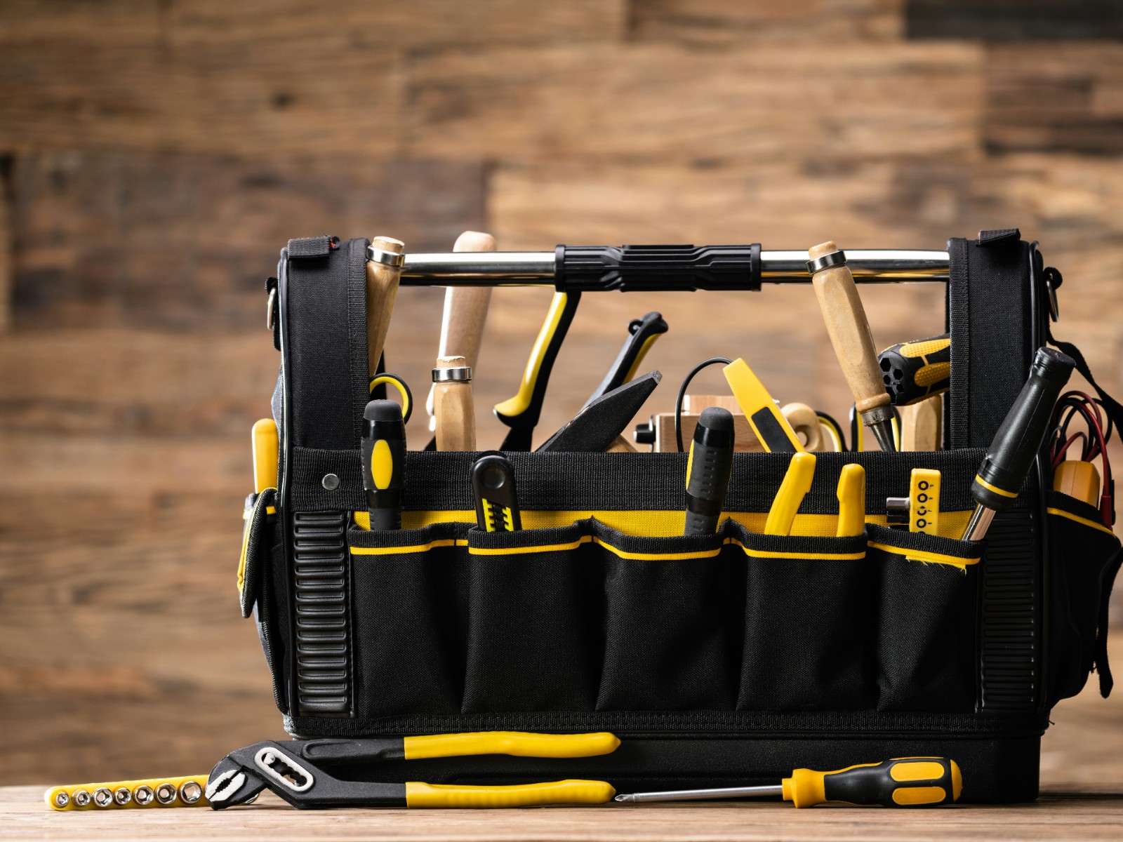 An open tool bag on a workbench, everything within reach.